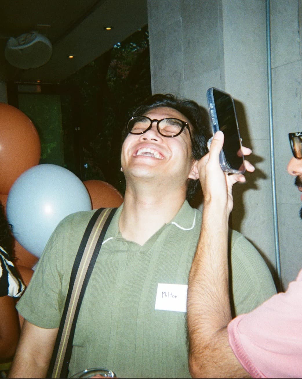 Guest wearing a name tag laughing at the launch event